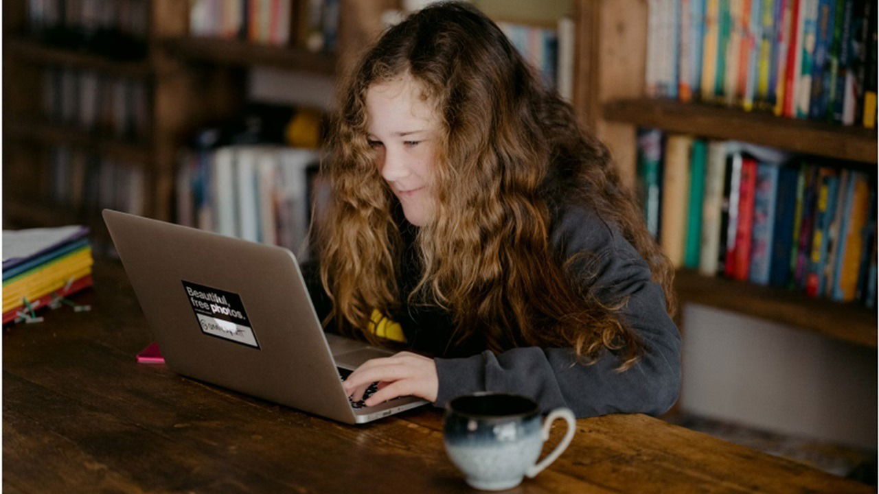 Student using a computer in a library.