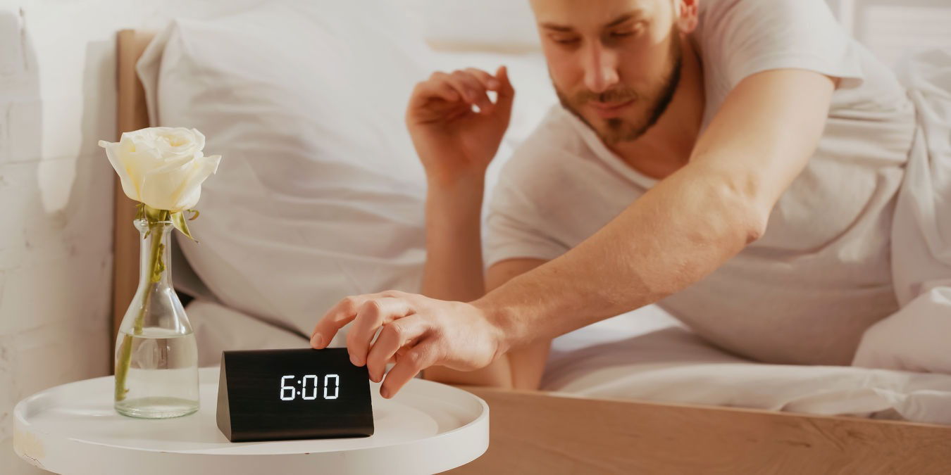 Man Using Smart Alarm Clock Wake Up