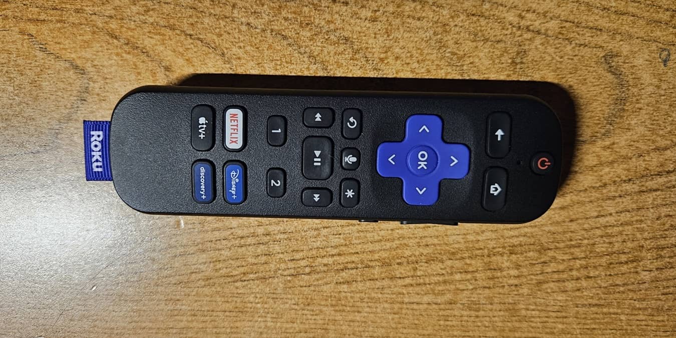 A Roku voice remote laying on its side.