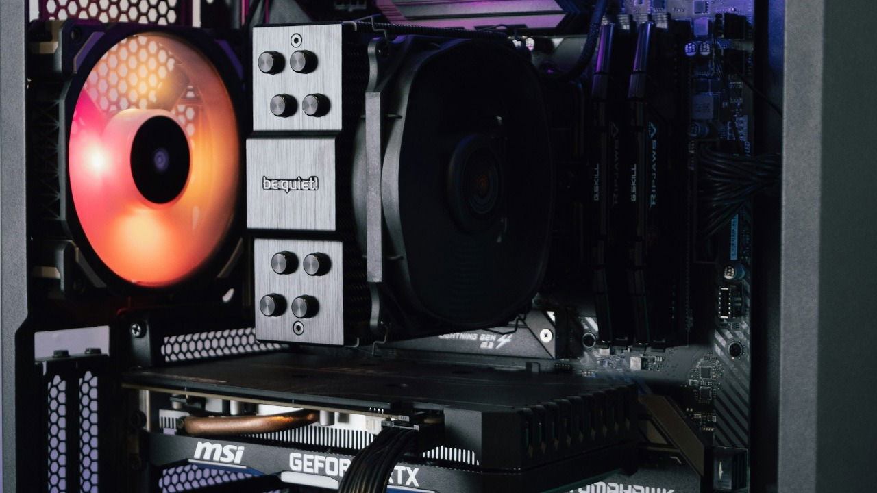 Close-up of a gaming PC showing a fan, CPU cooler, and graphics card