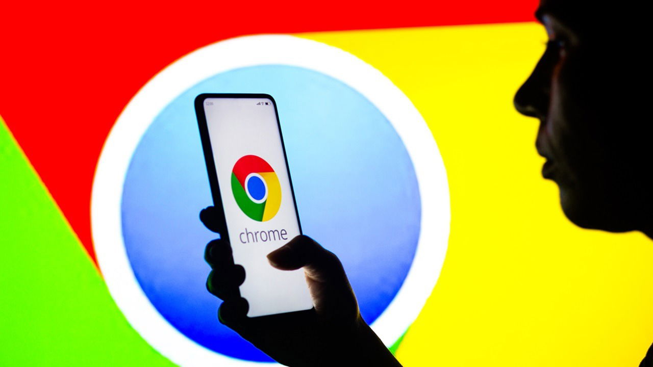 April 27, 2022, Brazil. In This Photo Illustration, A Silhouetted Woman Holds A Smartphone With The Google Chrome Logo Displayed On The Screen.